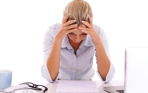 business woman with head in hands