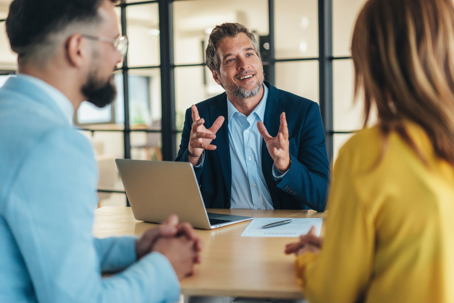 ocus on confident businessman talking to couple,